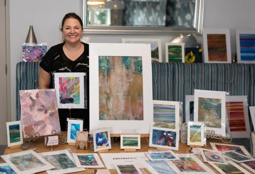 Woman smiling with artwork