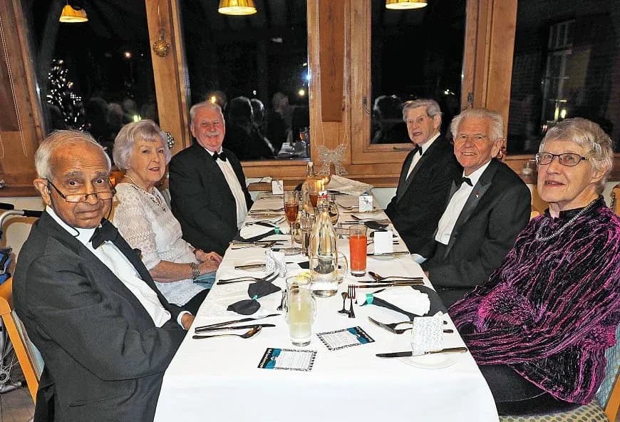 Residents enjoying a meal at a black-tie event