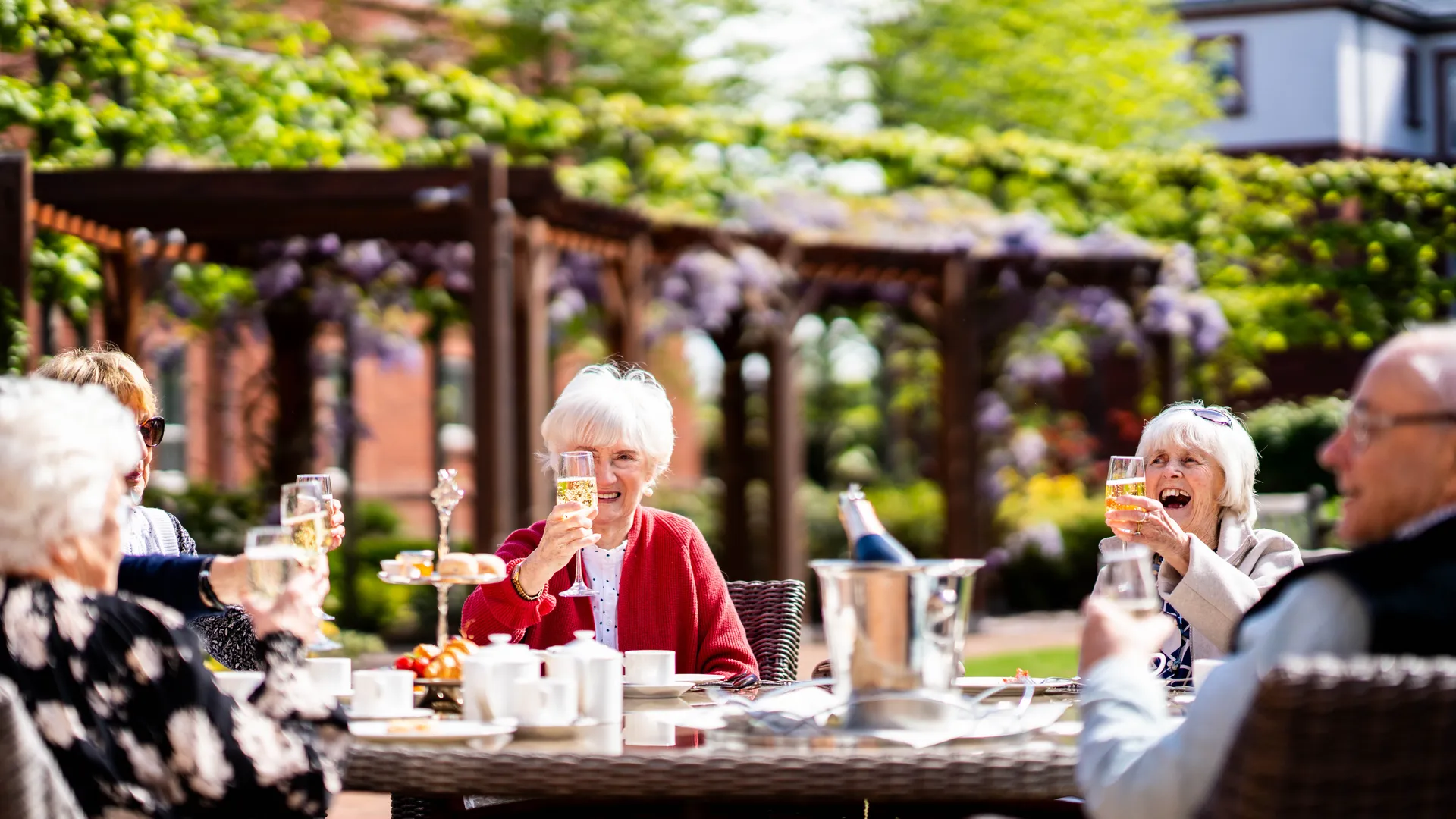 Boughton Hall residents enjoying drinks in the gardens