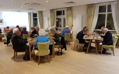 Residents sat around dinner tables eating