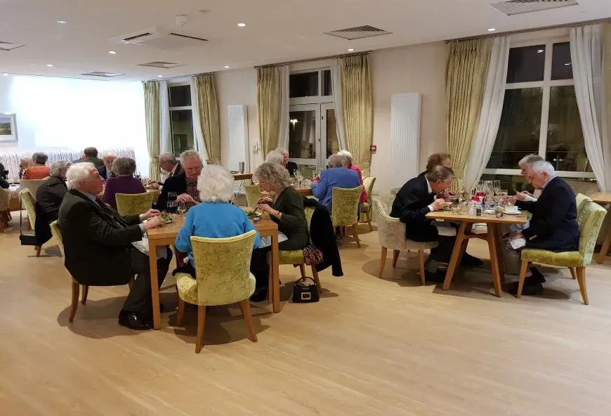 Residents sat around dinner tables eating