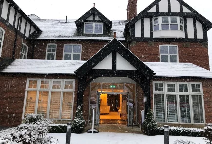 The outside of The red house with snow