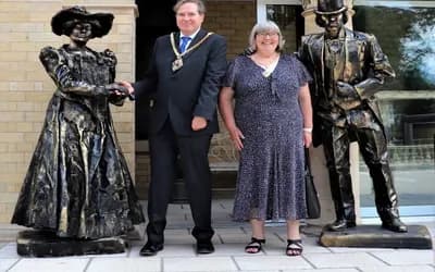 Two people stood with statues