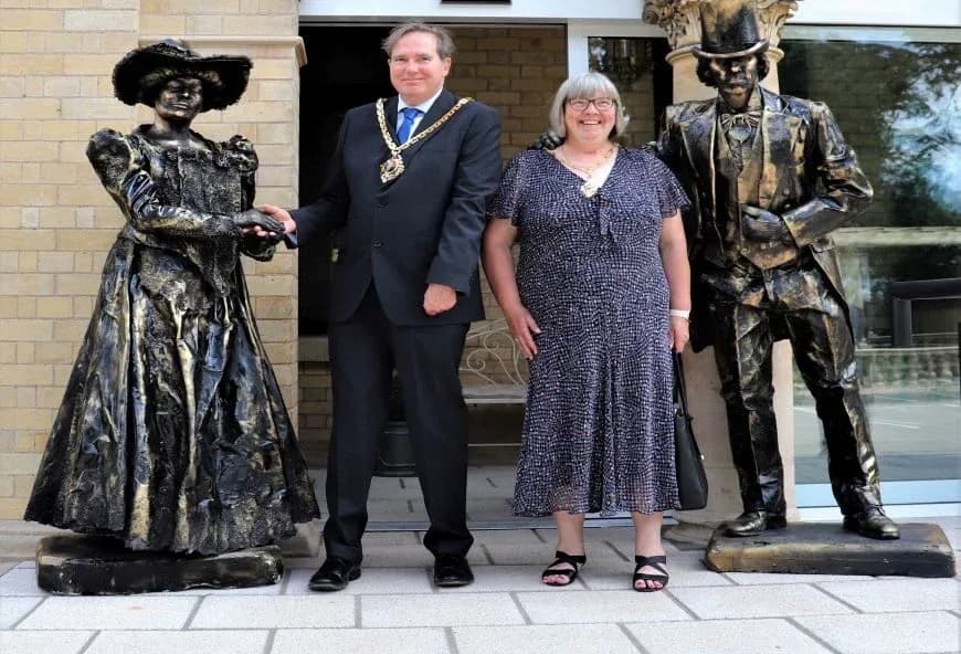 Two people stood with statues