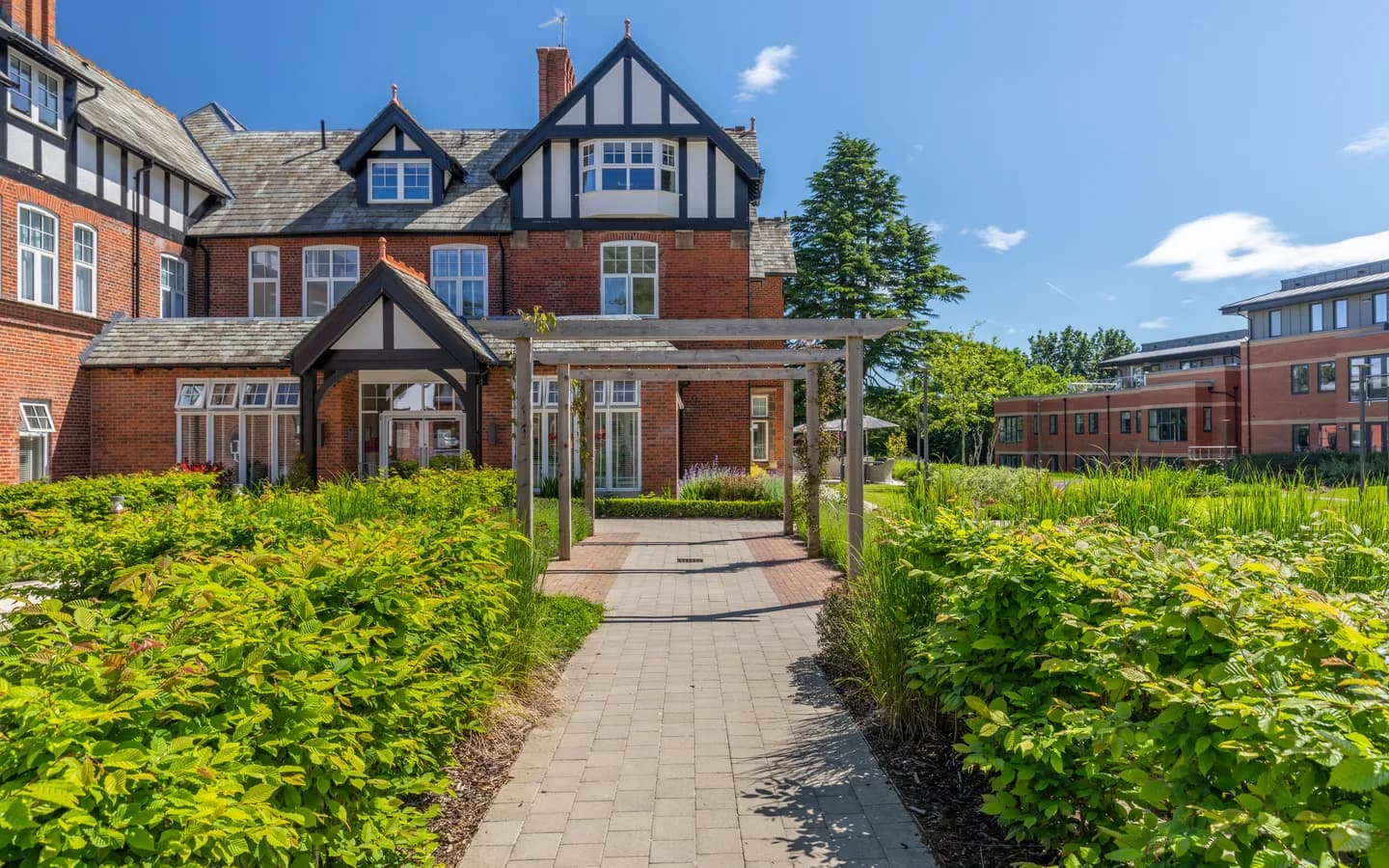 Outside of a house with a wooden arch