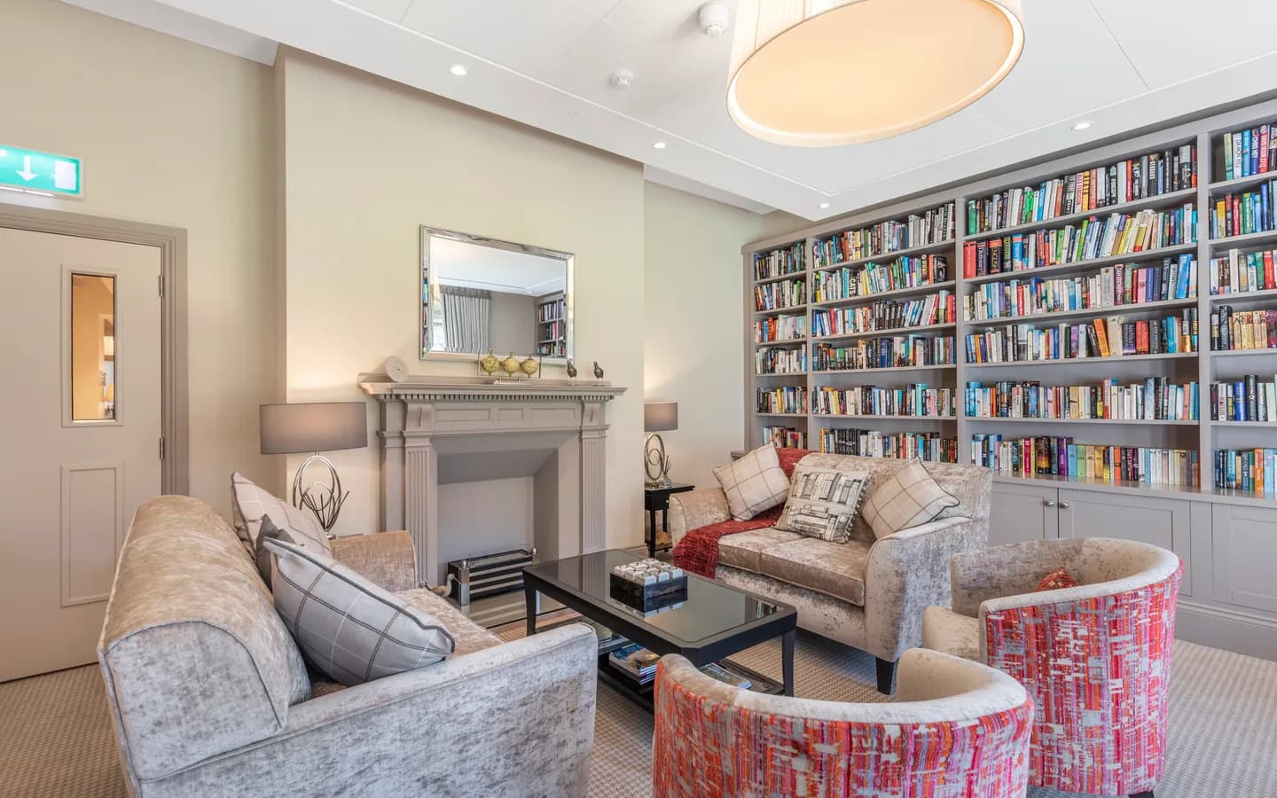 Two sofas with two chairs and a bookshelf