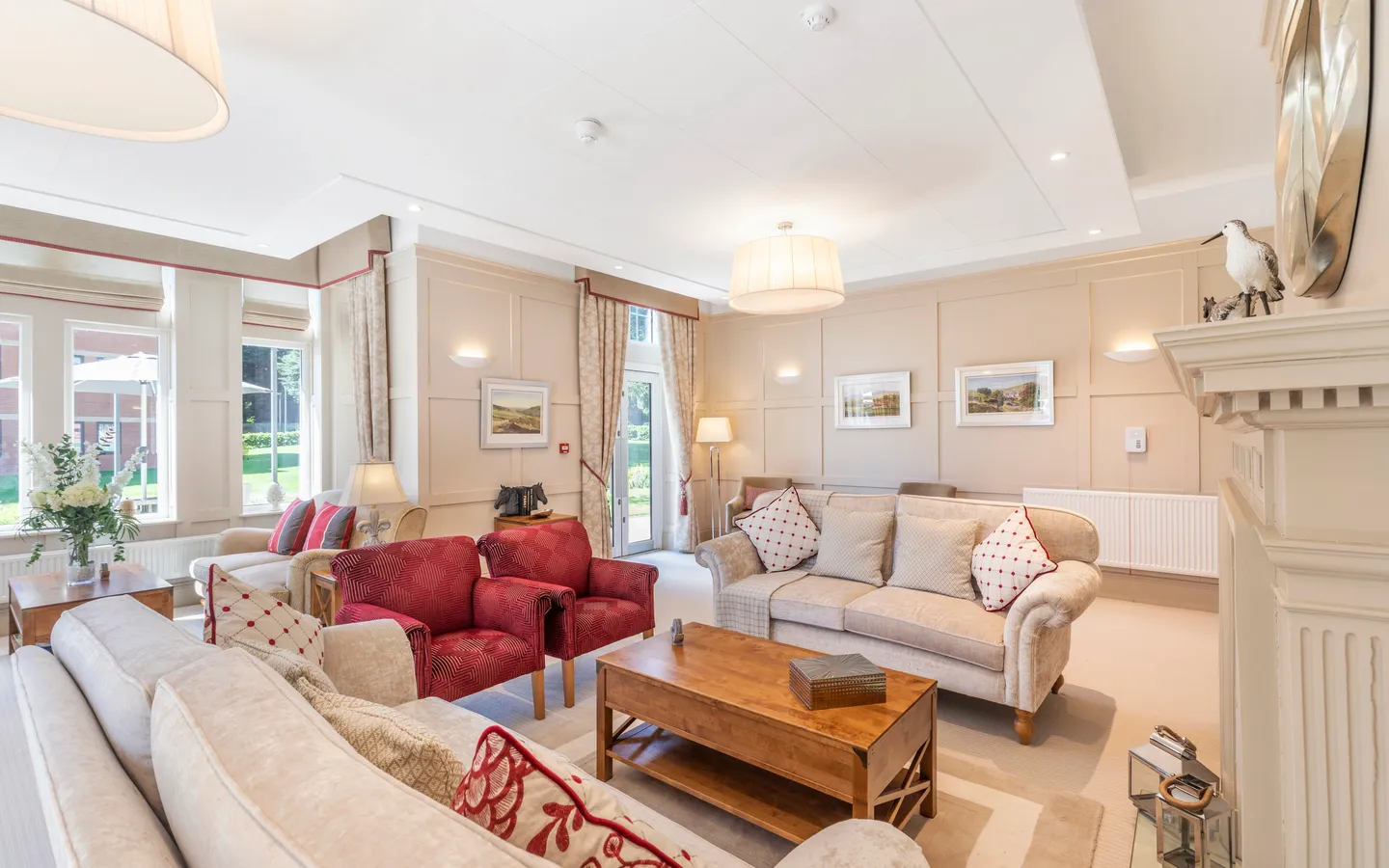 Two red chairs and two cream sofas