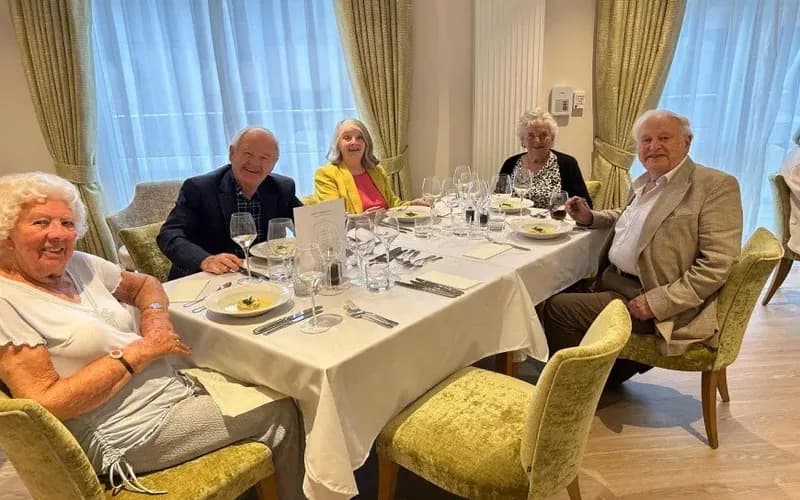 People eating a meal together at The Red House