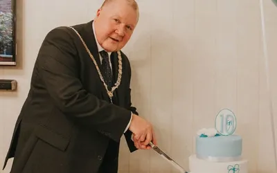 Deputy Lord Mayor of Chester cutting a cake