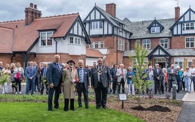 Lots of people outside red house celebrating.