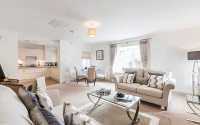 A living room/kitchen with a sofa and coffee table