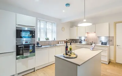 A grey and white kitchen with an island.