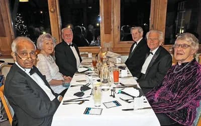 Residents enjoying a meal at a black-tie event