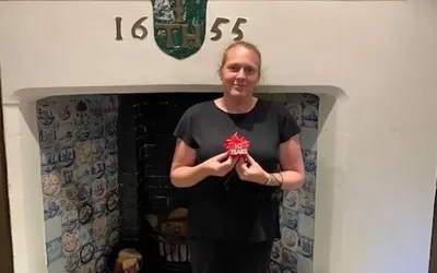 Boughton Hall employee, Alison, with a 10 year service award