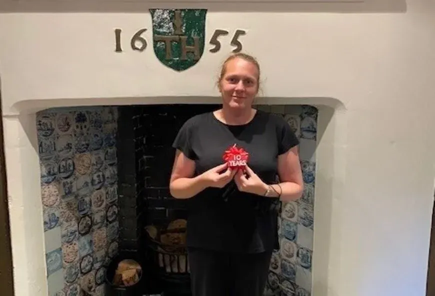 Boughton Hall employee, Alison, with a 10 year service award