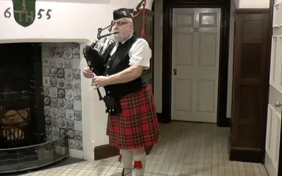Bagpipe player at Boughton Hall on Burns Night