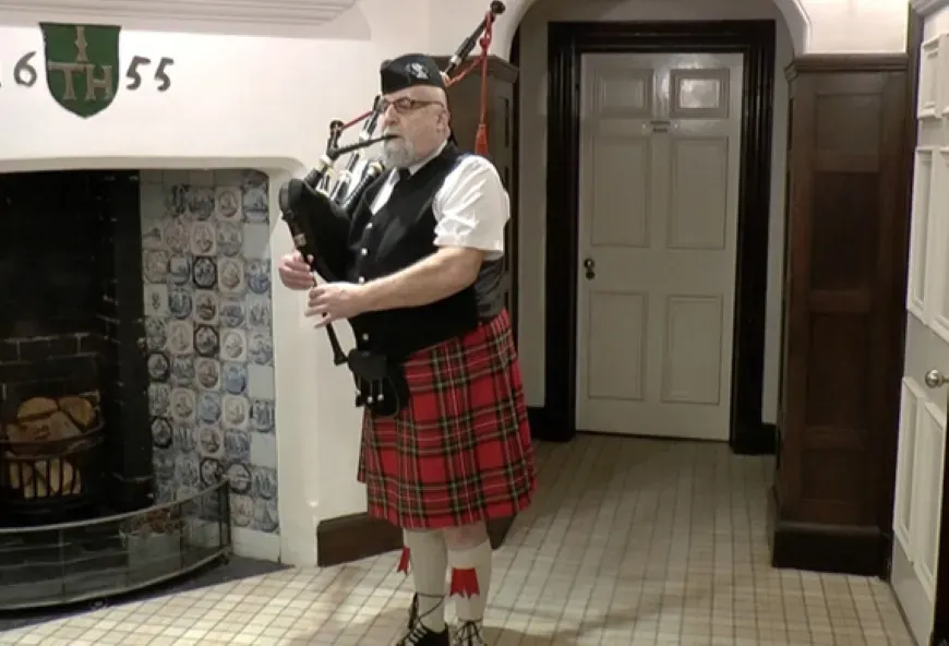 Bagpipe player at Boughton Hall on Burns Night