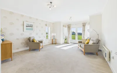 Living room in Apartment 19 Boughton Hall with French doors overlooking the cricket club.