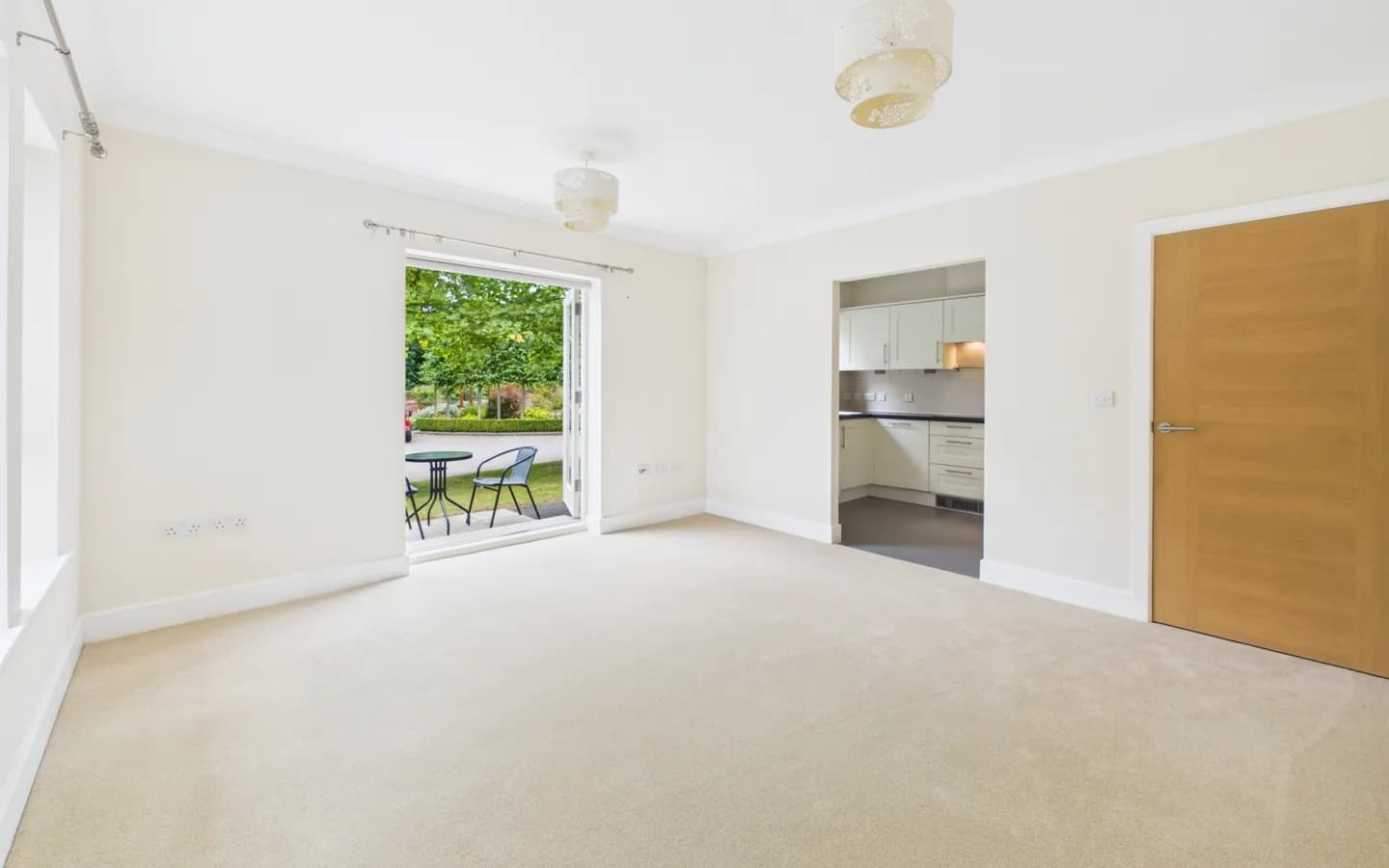 Apartment 26, Boughton Hall living/dining area with view through patio doors to gardens.