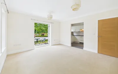Apartment 26, Boughton Hall living/dining area with view through patio doors to gardens.