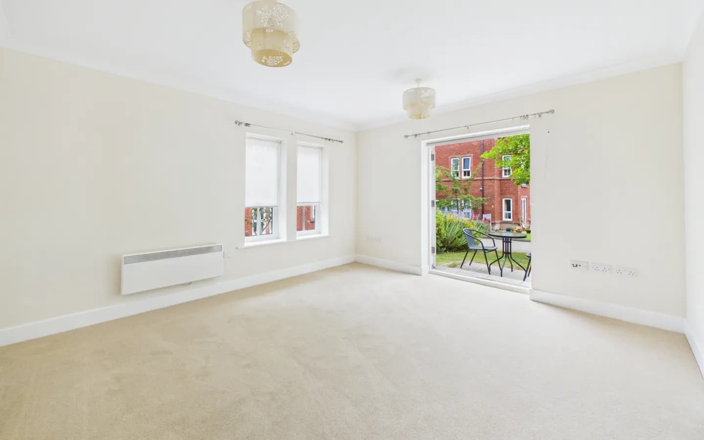 Apartment 26, Boughton Hall, living/dining area with French doors through to patio with garden views