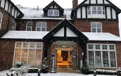 The outside of The red house with snow