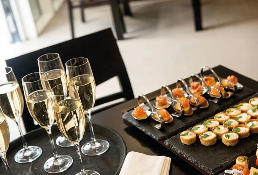 Two trays with prosecco and canapes