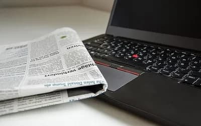 Laptop and newspaper