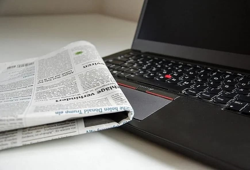 Laptop and newspaper
