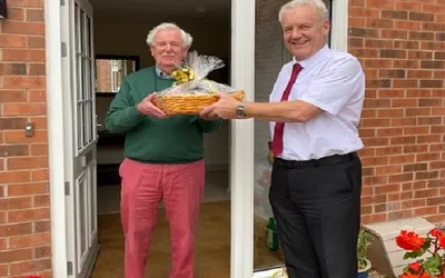 Kevan and James holding a hamper