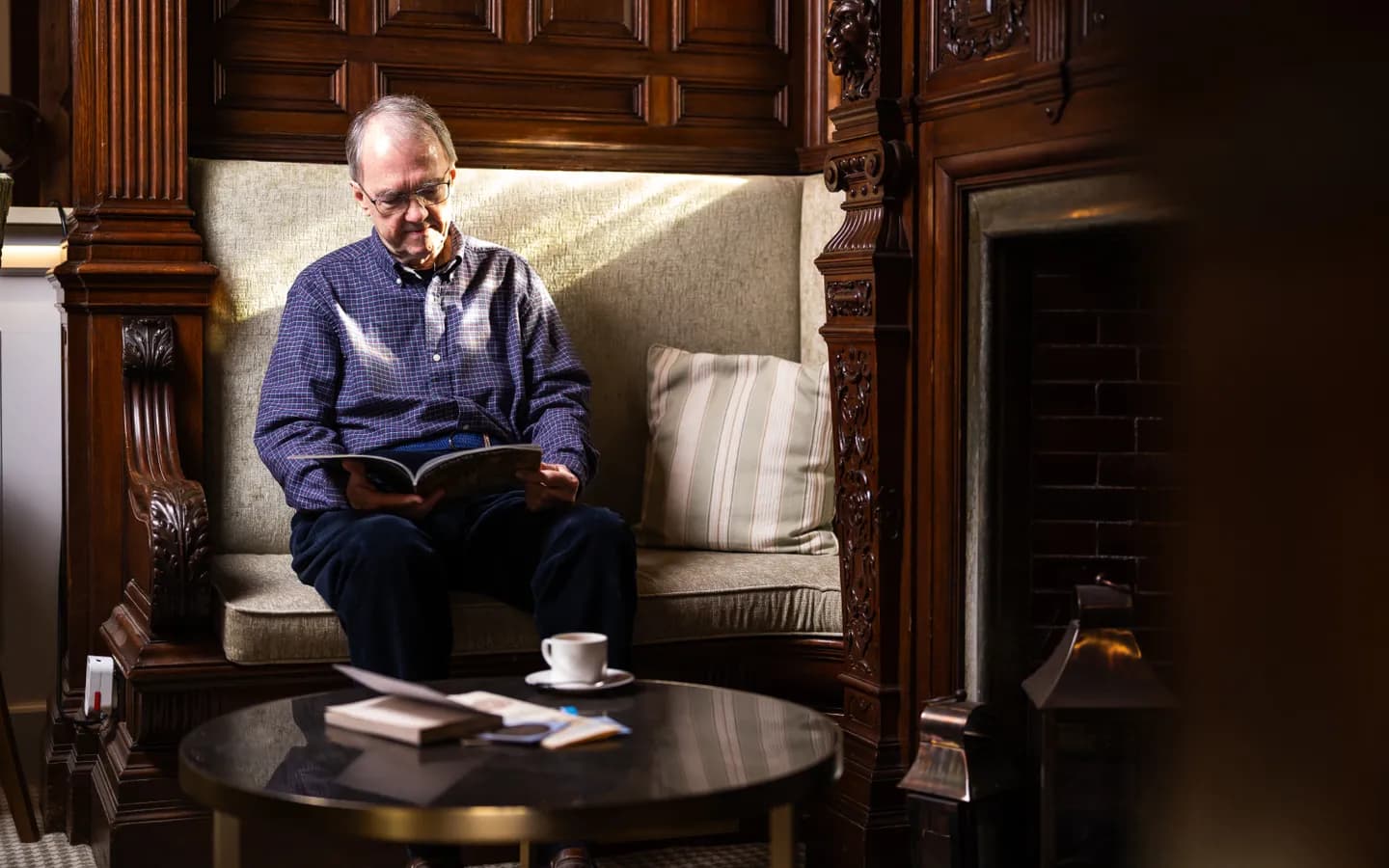 Mount Battenhall resident reading in the lounge