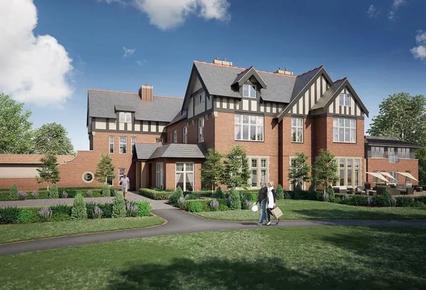 The outside of a large detached building with brick and black windows