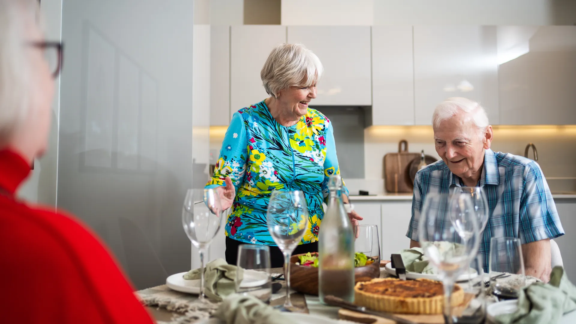 Residents having a meal in their apartment with friends