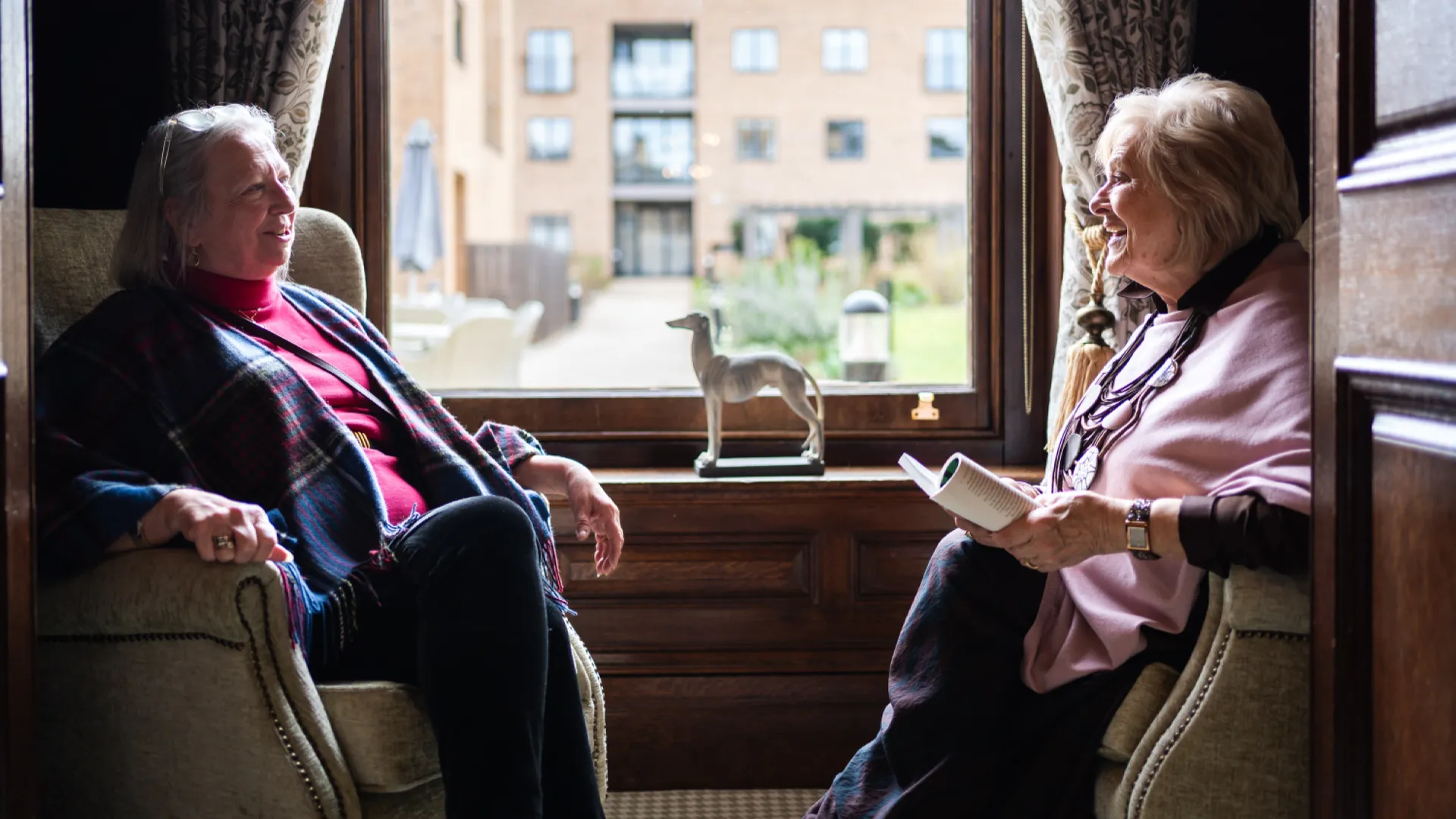 Residents sat by a window chatting