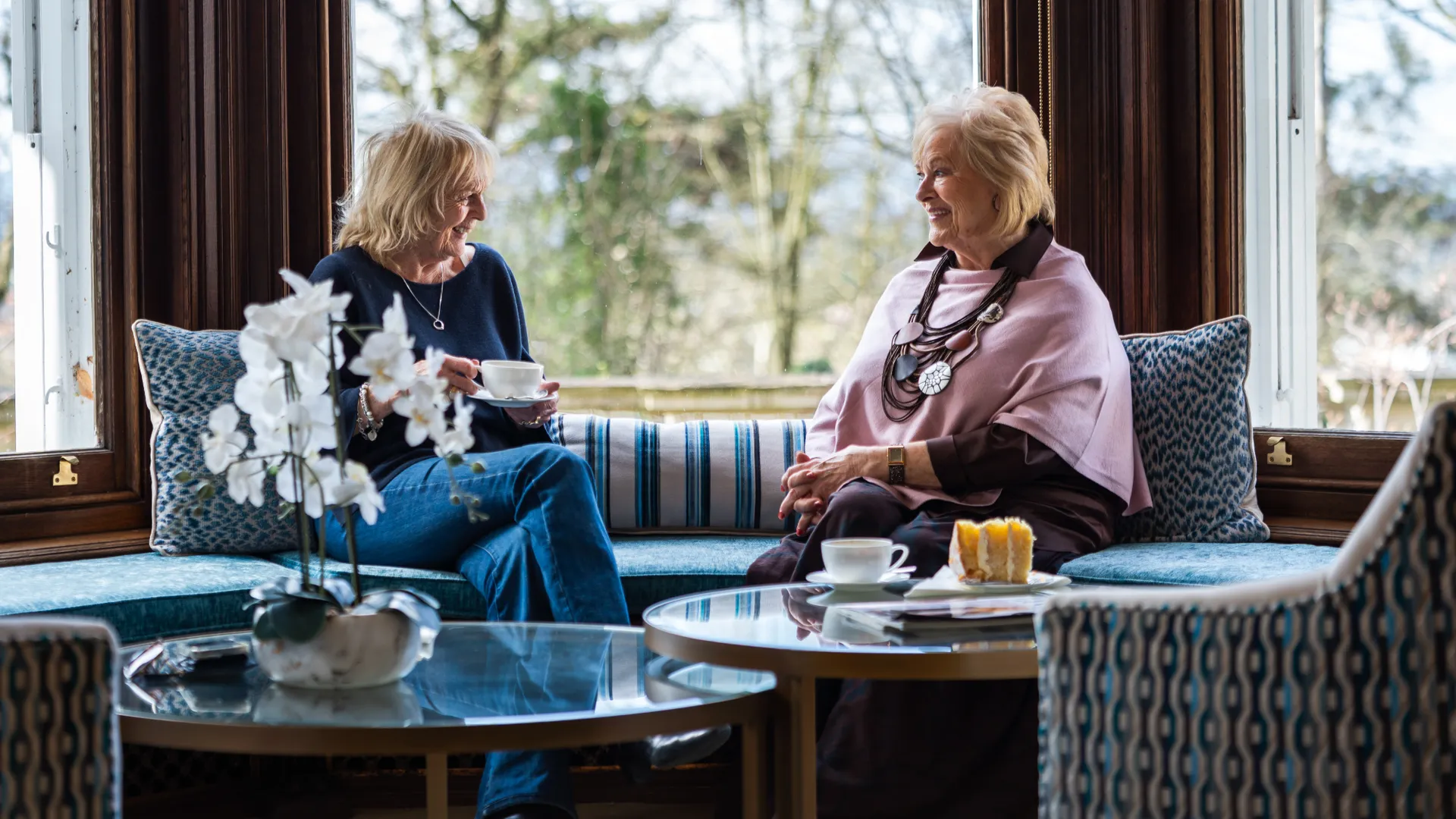 Residents sat in a bay window having a cup of tea