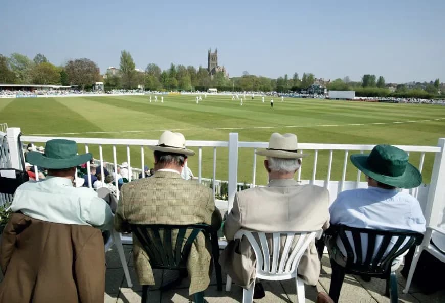 Four men sat watching the races