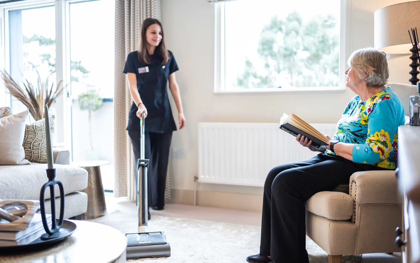 Staff vacuuming a resident's apartment