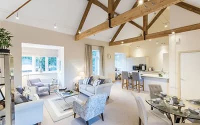 A show room with a kitchen and living room in it.