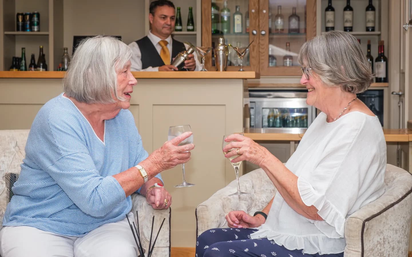 The Red House residents enjoying a glass of wine in the bar