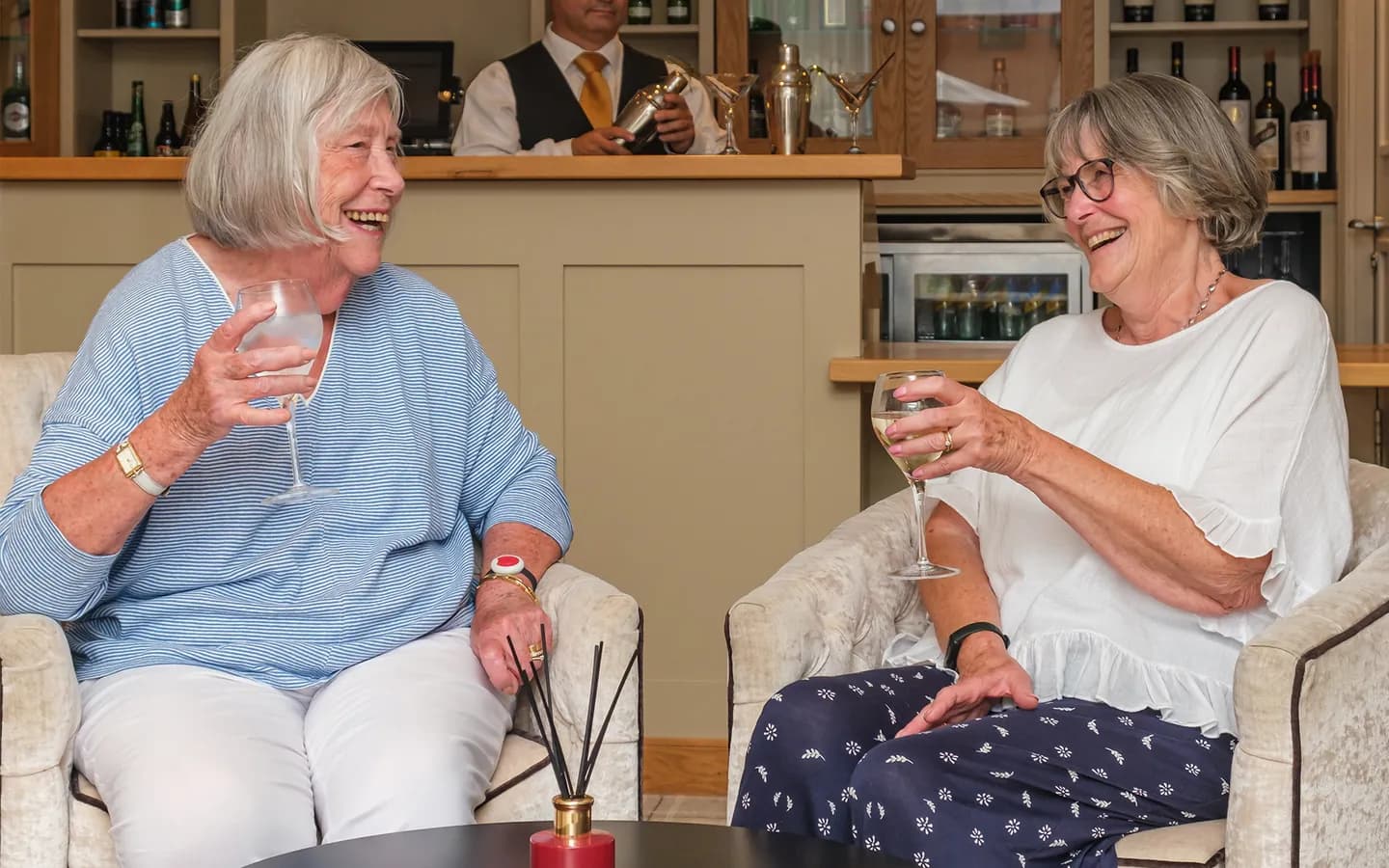 Two ladies enjoying a drink and catch up in the bar at The Red House Retirement Village in Ripon.