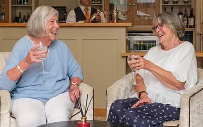 Two ladies enjoying a drink and catch up in the bar at The Red House Retirement Village in Ripon.