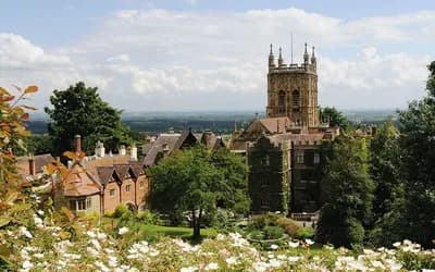 Scenic view of Worcester Cathedral and historic buildings surrounded by gardens and countryside in Worcester, England.