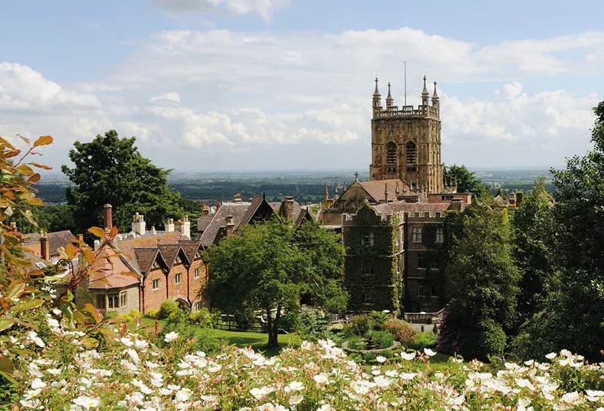 Scenic view of Worcester Cathedral and historic buildings surrounded by gardens and countryside in Worcester, England.